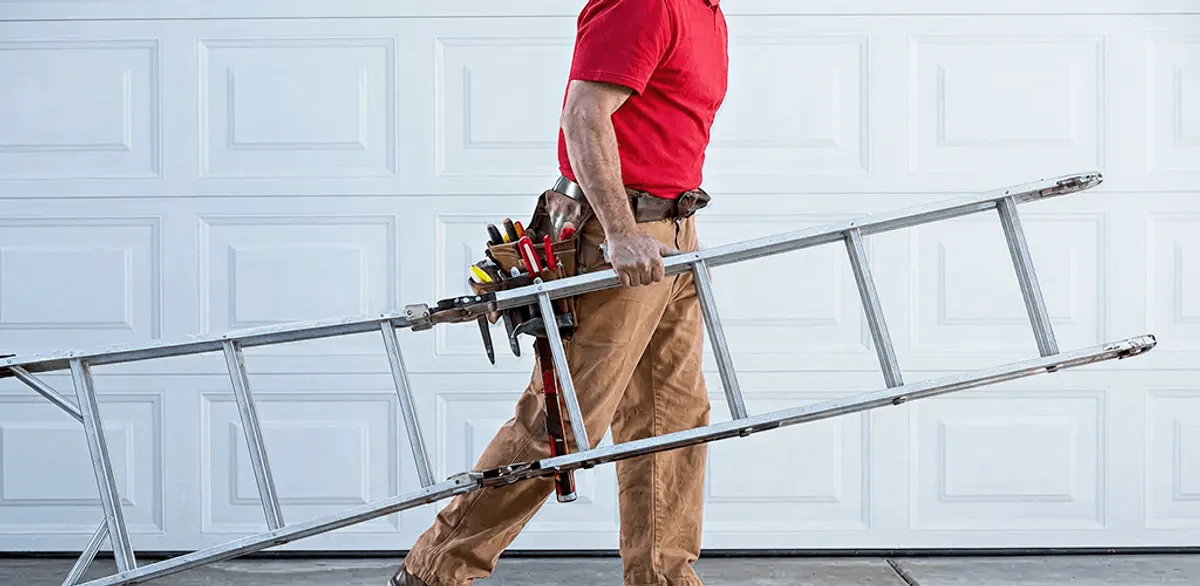 Garage door repair technician arriving with tools and ladder in Grand Rapids, MI